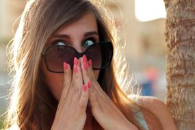 photo of a surprised girl in sunglasses