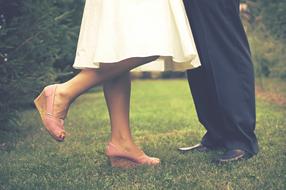 photo of lovers feet on the lawn