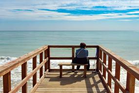 elderly person on pier on a sunny day