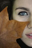portrait of maple leaf at Womanâs face