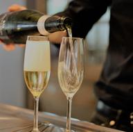 man pouring Champagne to glass