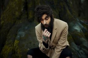 sitting man with overgrown beard