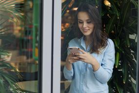 adult Woman with smartphone smiling