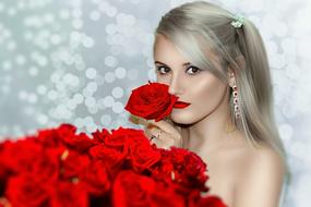 beautiful blonde with a huge bouquet of red roses