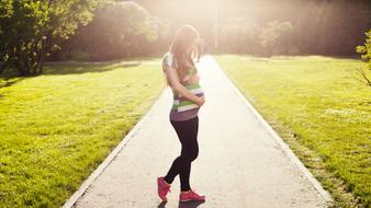 pregnant on a walk in the park on a sunny day