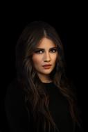 low key Portrait of serious young Woman at dark background