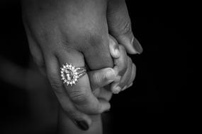child's hand and an adult with a ring