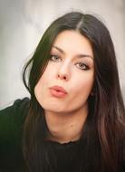 Portrait of a woman with make-up, blowing lips
