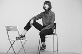 cool young woman posing in stylish shoes