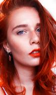 photo portrait of a red-haired girl with orange lipstick