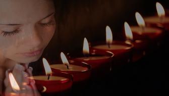 praying woman and candles