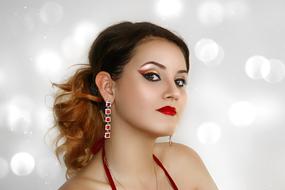 Girl with long earrings and bright makeup