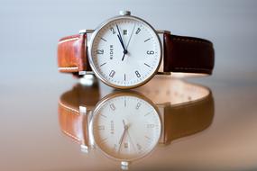 classic Analog Wrist Watch on mirroring surface
