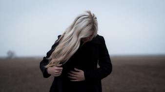 girl in black clothes on the street during the fog
