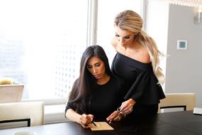 two adult Woman with tablet in office