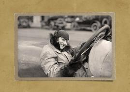 vintage picture of a woman with steering wheel on the surface