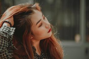 young woman with long hair on blurred background