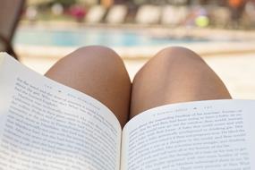 reading book by the pool