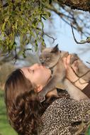 woman holding a grey cat