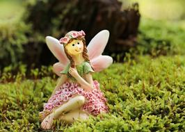 elf as a figurine on green moss