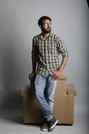 young man posing near the armchair