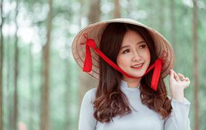Portrait of pretty asian Girl in cone hat with red band