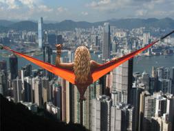 Girl laying on Hammock at Hong Kong skyline, collage
