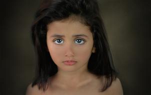 Portrait of a girl with big, shiny eyes