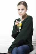 Young Lovely Woman sits with cold drink in hand