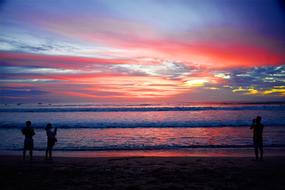 silhouettes of tourists on Kuta Beach