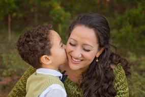 happy mom with son on blurred background