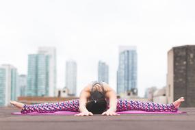 Girl pose stretching against the backdrop of the cityscape