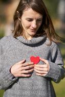 Valentineâs Day Celebration, young girl with red heart on grey clothing