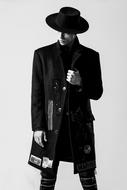 black and white, a man in a classic coat and hat