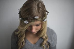 blonde with a wreath on her head close-up