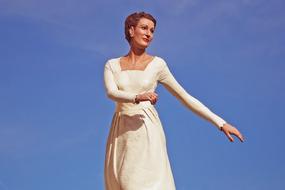 woman in white posing on a sunny day