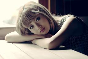 photo of a young cute girl lying on the table