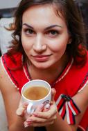 young pretty Woman holding cup with drink