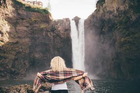 blonde with a scarf on the background of a waterfall