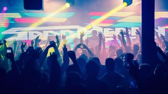 crowd of People with hands up on performance