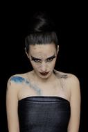 Young Woman with paint on body in darkness