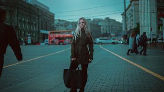 photo of a model with a big bag on a city street