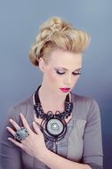 portrait of a beautiful blonde with a large necklace