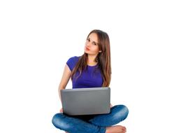 young Girl sits with laptop computer, cut out