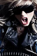 Portrait of a blonde girl in rock clothing and glasses