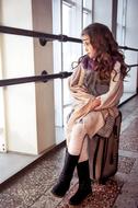 Portrait of Girl Model sitting on suitcase