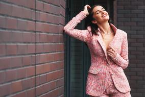 happy woman in pink business suit