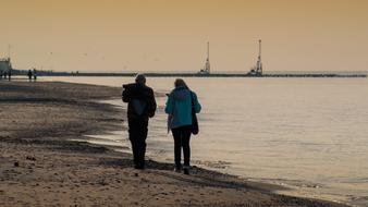 people walking along the beach