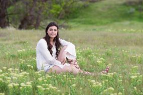 beautiful girl posing on a spring meadow