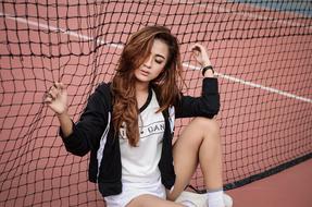 indonesian model posing on tennis court